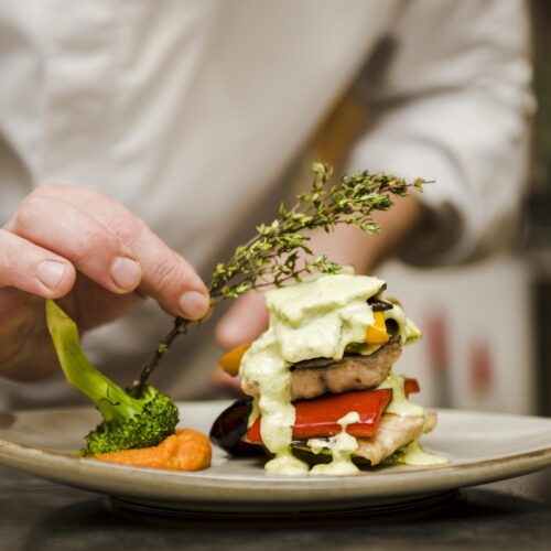chef-placing-herb-gourmet-meal